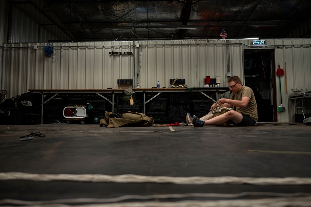 82nd ERQS Airman prepares parachutes for regional operations