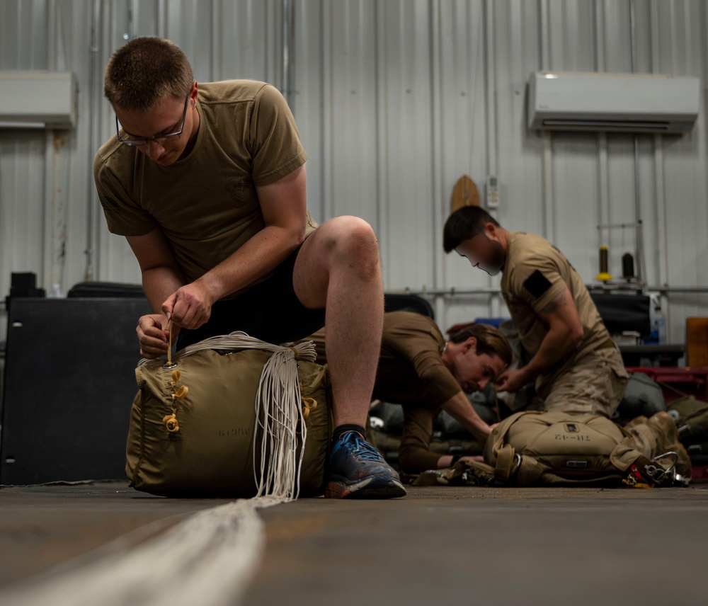 82nd ERQS Airman prepares parachutes for regional operations