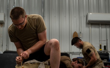 82nd ERQS Airman prepares parachutes for regional operations