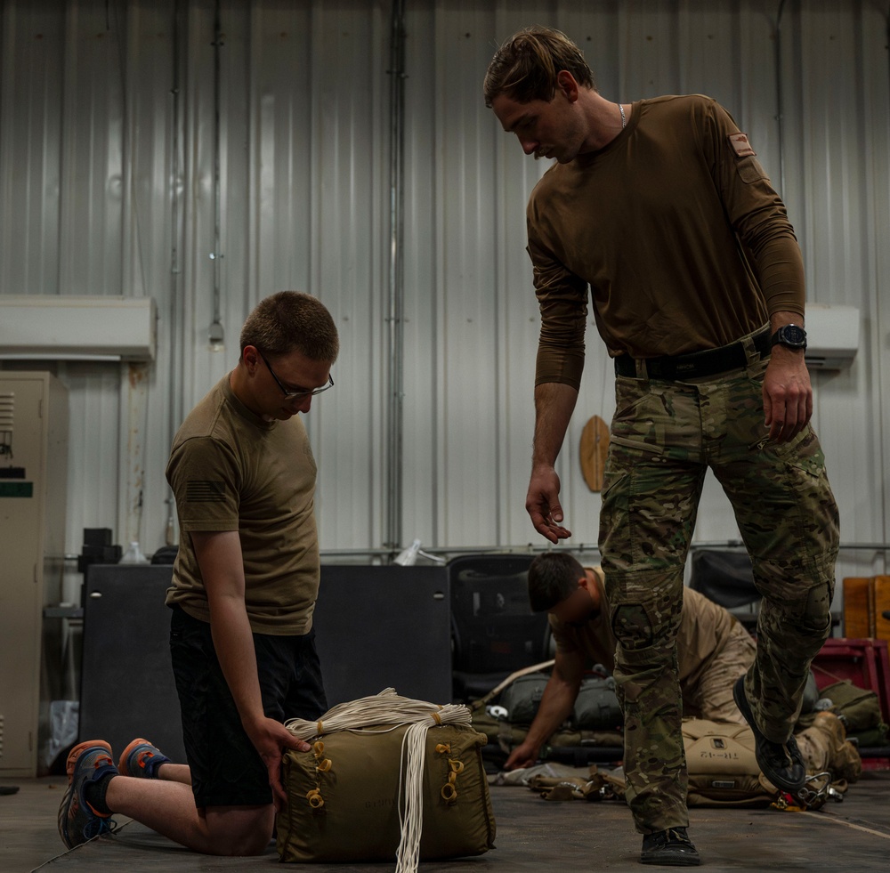 82nd ERQS Airman prepares parachutes for regional operations