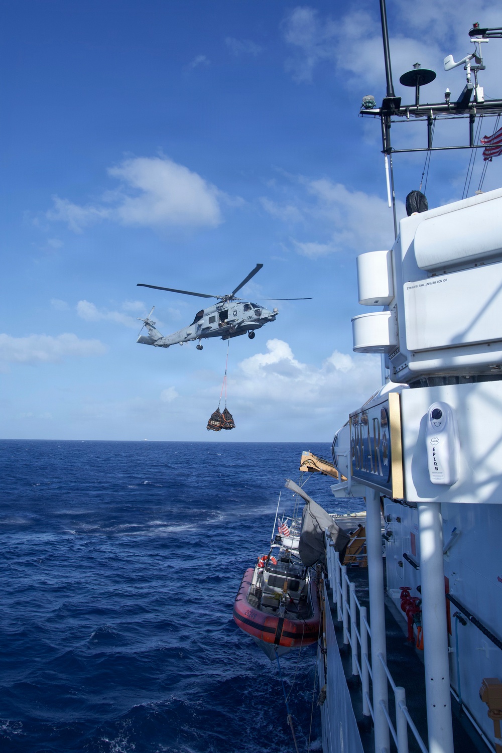 Coast Guard Cutter Bear, U.S. Navy aircrews conduct vertical replenishment operations in the Caribbean Sea