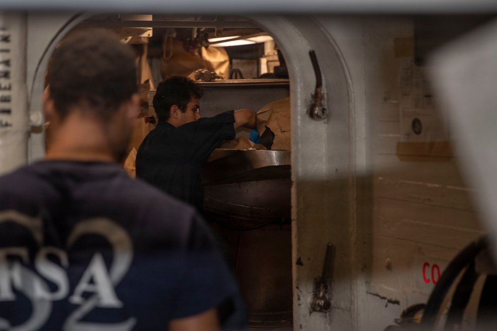 Abraham Lincoln Sailors sort trash