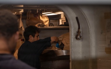 Abraham Lincoln Sailors sort trash