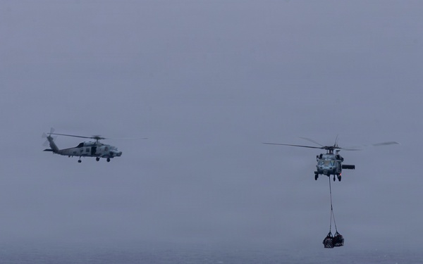 Abraham Lincoln conducts a replenishment-at-sea with Henry J. Kaiser and Cesar Chavez