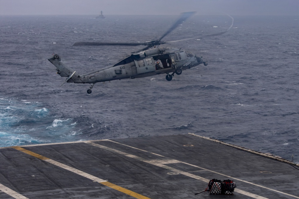 Abraham Lincoln conducts a replenishment-at-sea with Henry J. Kaiser and Cesar Chavez
