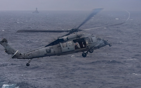Abraham Lincoln conducts a replenishment-at-sea with Henry J. Kaiser and Cesar Chavez