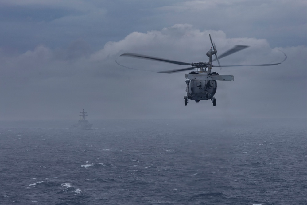 Abraham Lincoln conducts a replenishment-at-sea with Henry J. Kaiser and Cesar Chavez