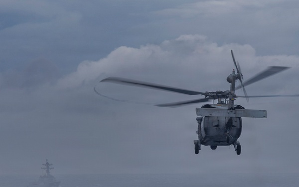 Abraham Lincoln conducts a replenishment-at-sea with Henry J. Kaiser and Cesar Chavez
