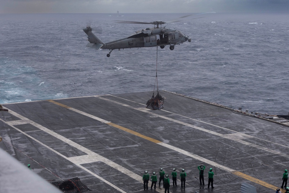 Abraham Lincoln conducts a replenishment-at-sea with Henry J. Kaiser and Cesar Chavez