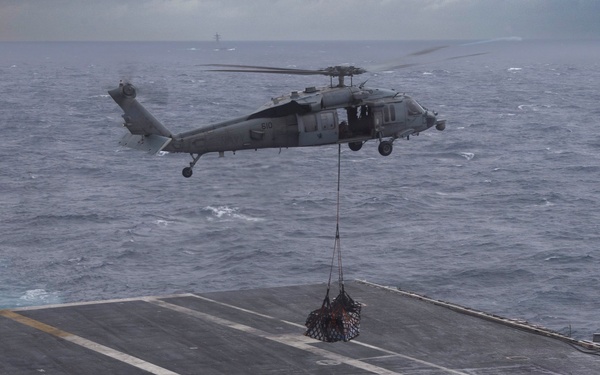 Abraham Lincoln conducts a replenishment-at-sea with Henry J. Kaiser and Cesar Chavez
