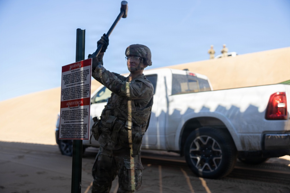 Soldiers place NDA 5 signs