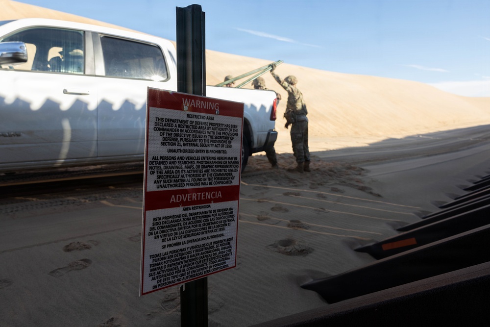 Soldiers place NDA 5 signs