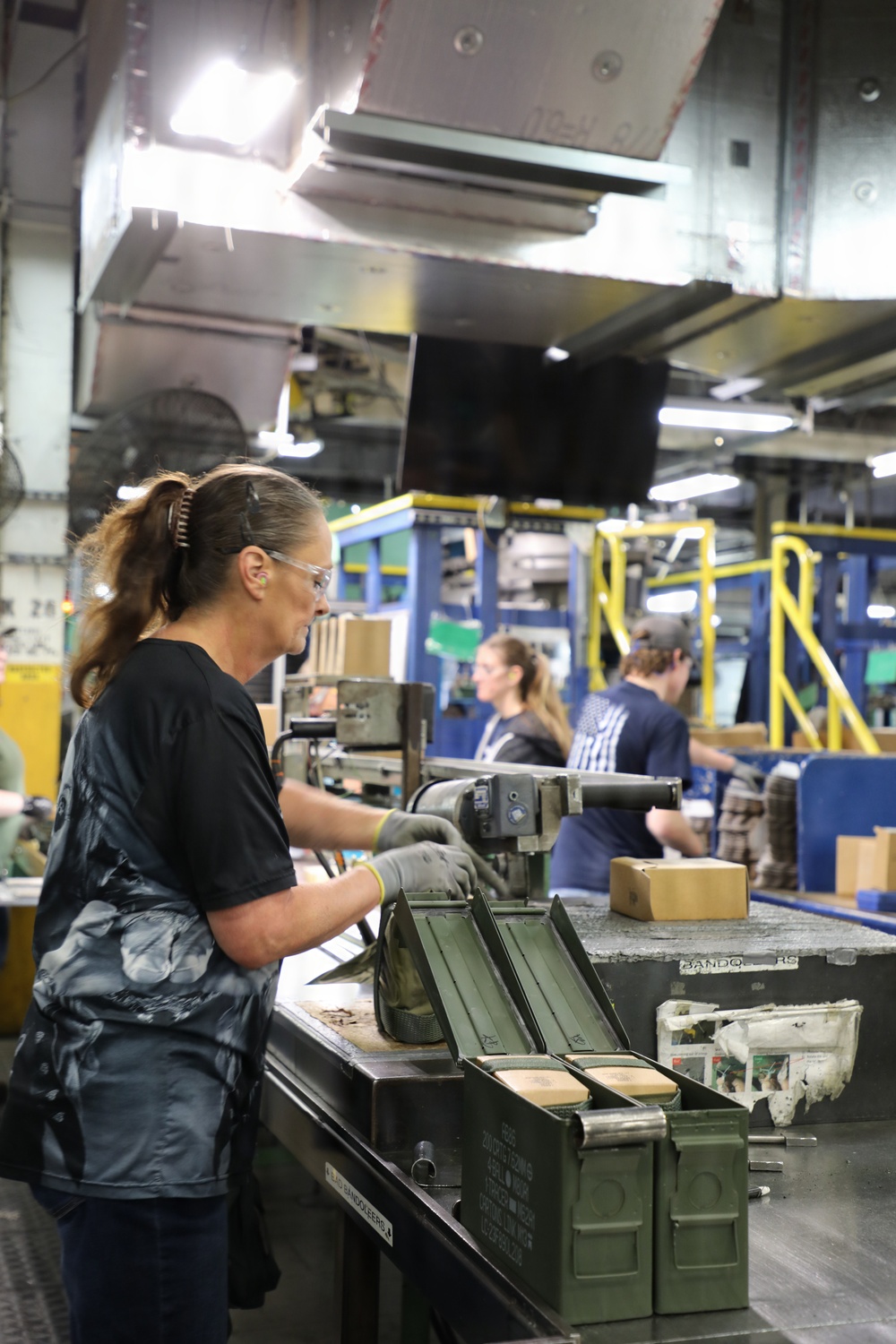 Packing ammo boxes for distribution at Lake City Army Ammunition Plant