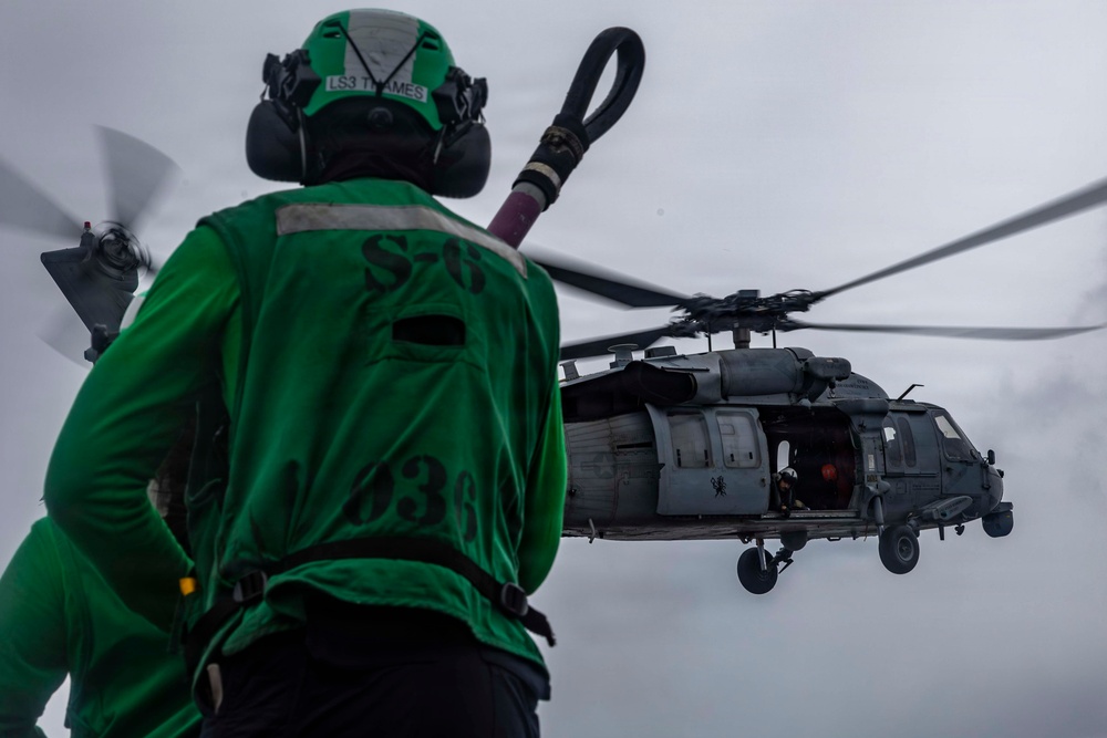 Abraham Lincoln conducts a replenishment-at-sea with Henry J. Kaiser and Cesar Chavez