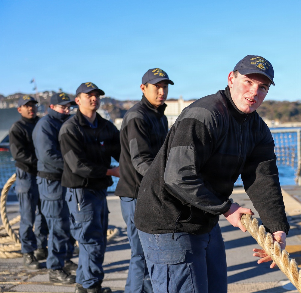 Sailors aboard the USS John Finn conduct a sea and anchor detail in Yokosuka, Japan