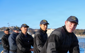 Sailors aboard the USS John Finn conduct a sea and anchor detail in Yokosuka, Japan
