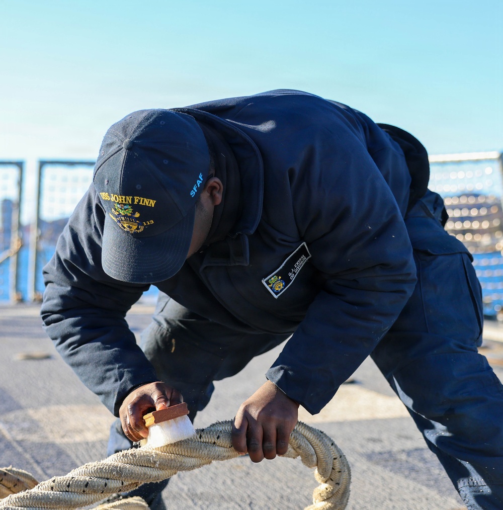 Sailors aboard the USS John Finn conduct a sea and anchor detail in Yokosuka, Japan