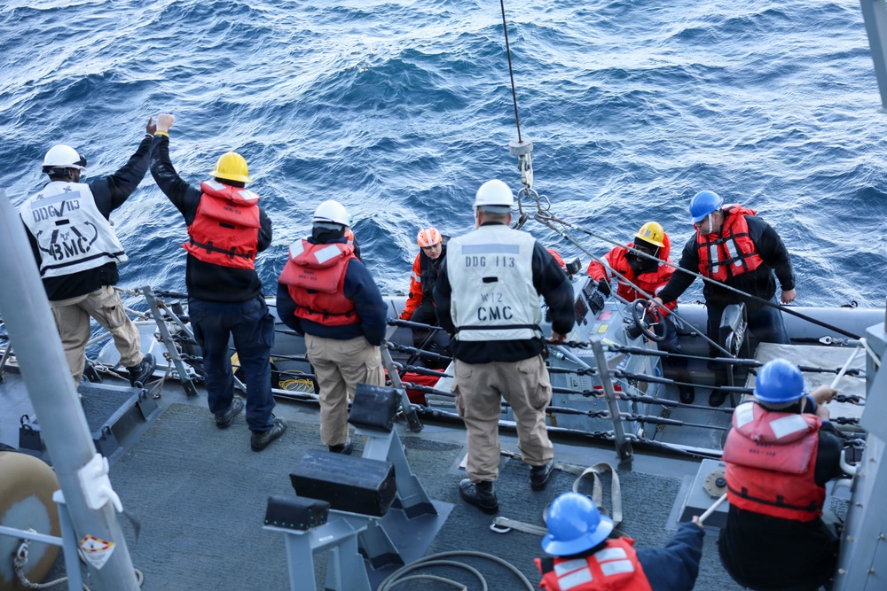 Sailors aboard the USS John Finn conduct a small boat operation in Yokosuka, Japan