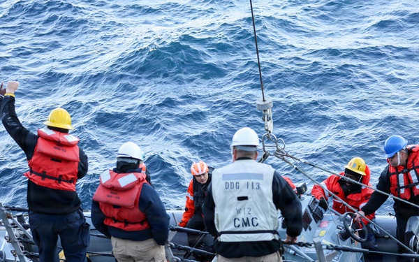 Sailors aboard the USS John Finn conduct a small boat operation in Yokosuka, Japan