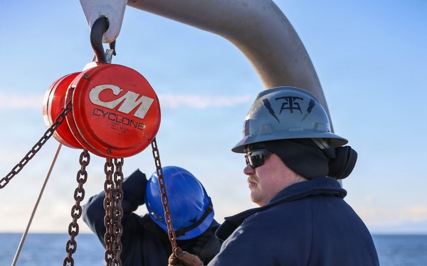 Sailors aboard the USS John Finn conduct a torpedo upload in Yokosuka, Japan