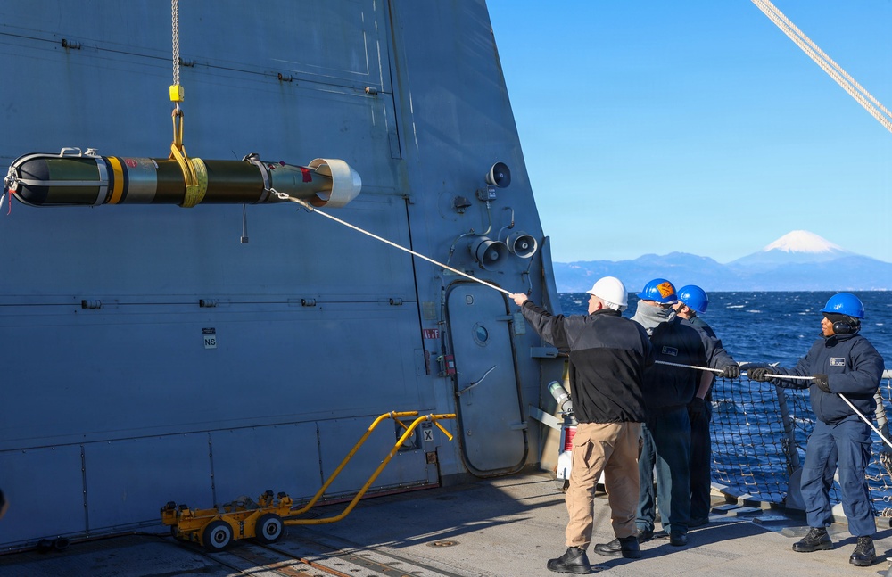 Sailors aboard the USS John Finn conduct a torpedo upload in Yokosuka, Japan