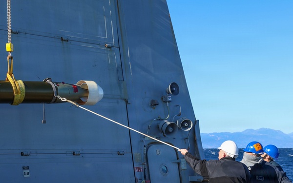 Sailors aboard the USS John Finn conduct a torpedo upload in Yokosuka, Japan
