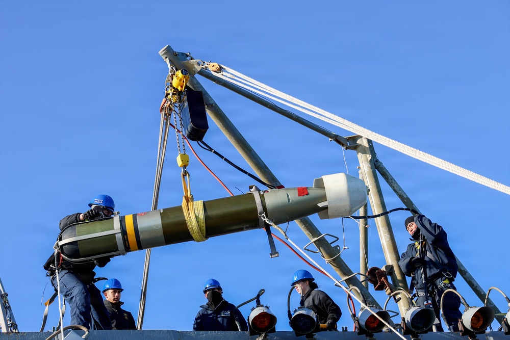 Sailors aboard the USS John Finn conduct a torpedo upload in Yokosuka, Japan