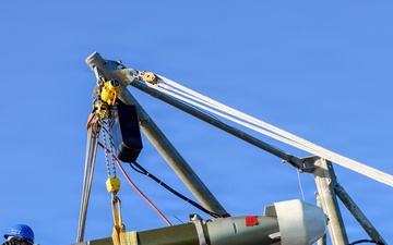 Sailors aboard the USS John Finn conduct a torpedo upload in Yokosuka, Japan