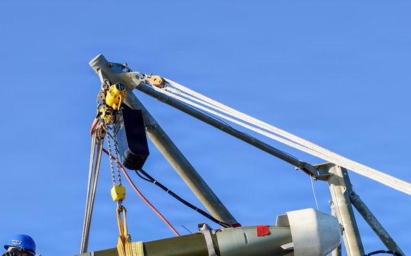 Sailors aboard the USS John Finn conduct a torpedo upload in Yokosuka, Japan