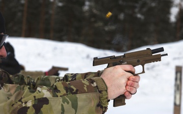 U.S. Army Staff Sgt. Austin Inclema conducts pistol qualifications