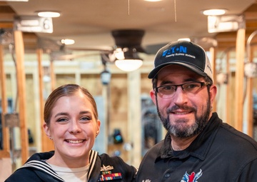 Recruiter speaks to students of school she attended before the Navy