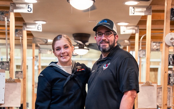 Recruiter speaks to students of school she attended before the Navy