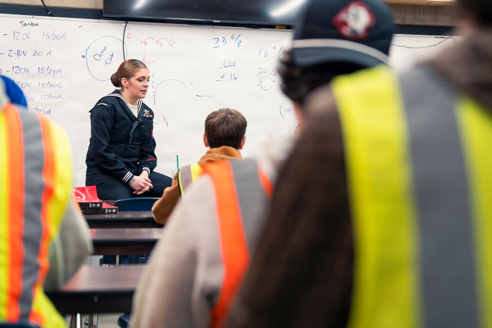 Recruiter speaks to students of school she attended before the Navy
