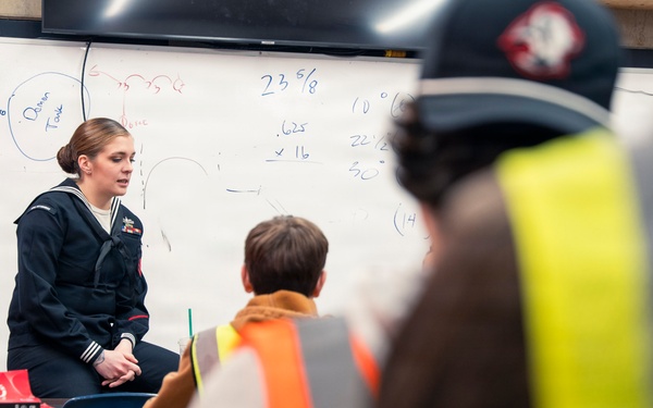 Recruiter speaks to students of school she attended before the Navy