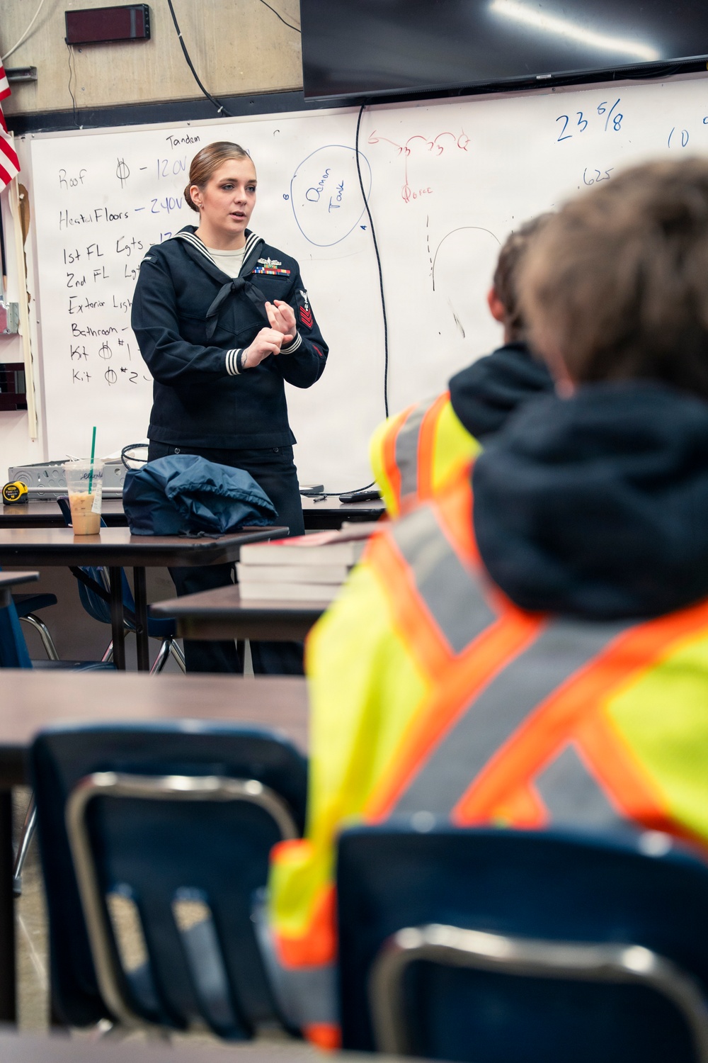 Recruiter speaks to students of school she attended before the Navy