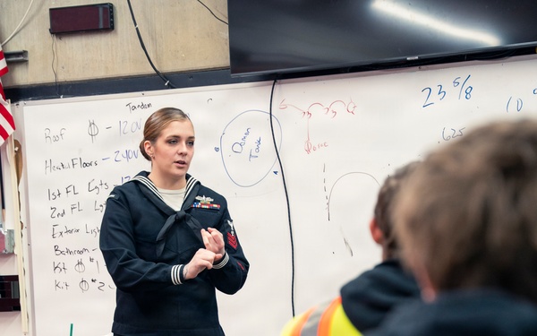 Recruiter speaks to students of school she attended before the Navy
