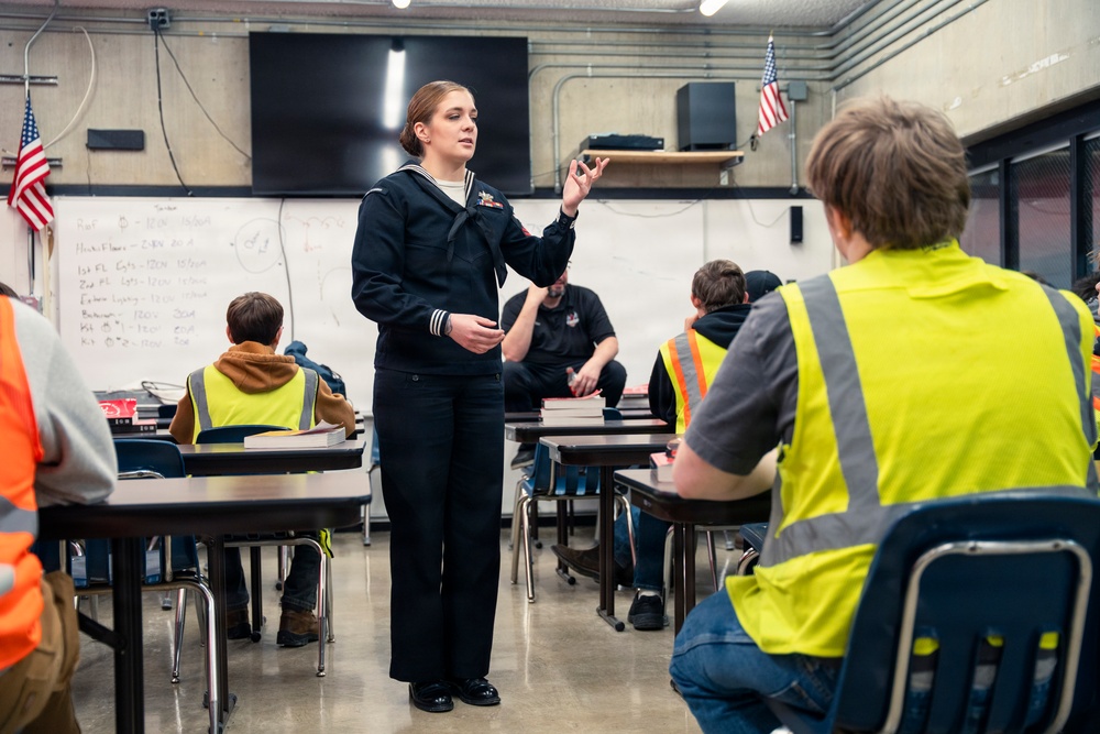 Recruiter speaks to students of school she attended before the Navy