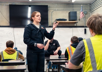Recruiter speaks to students of school she attended before the Navy