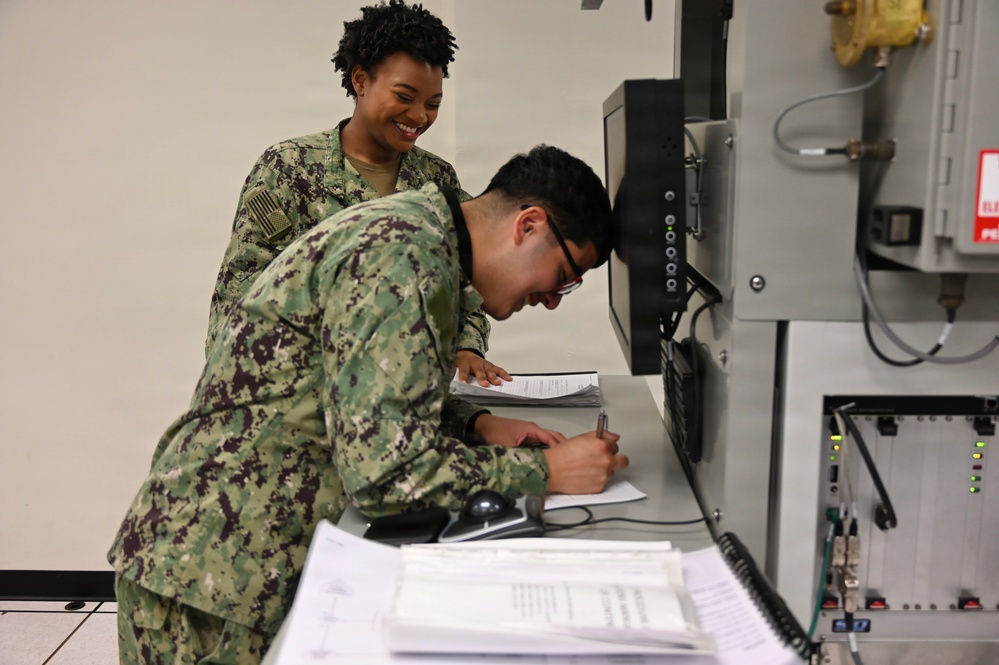 Electronics Technician students troubleshoot the T-1 radar trainer.