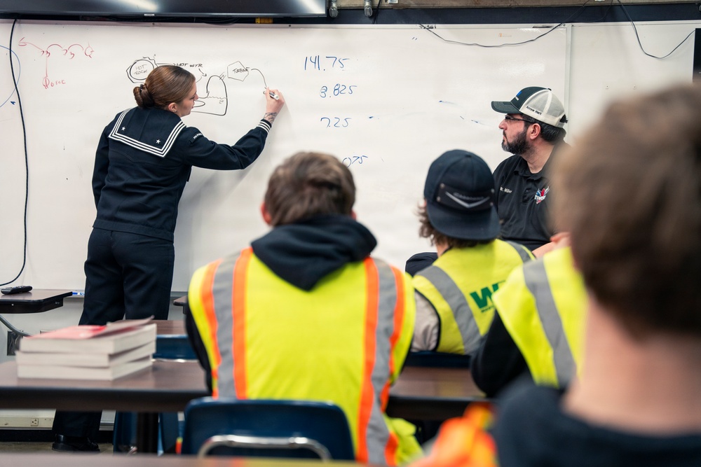 Recruiter speaks to students of school she attended before the Navy