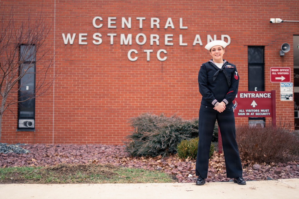 Recruiter speaks to students of school she attended before the Navy