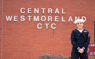 Recruiter speaks to students of school she attended before the Navy