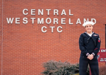 Recruiter speaks to students of school she attended before the Navy