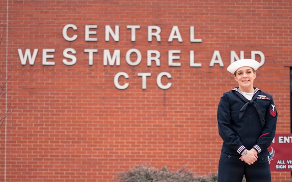 Recruiter speaks to students of school she attended before the Navy