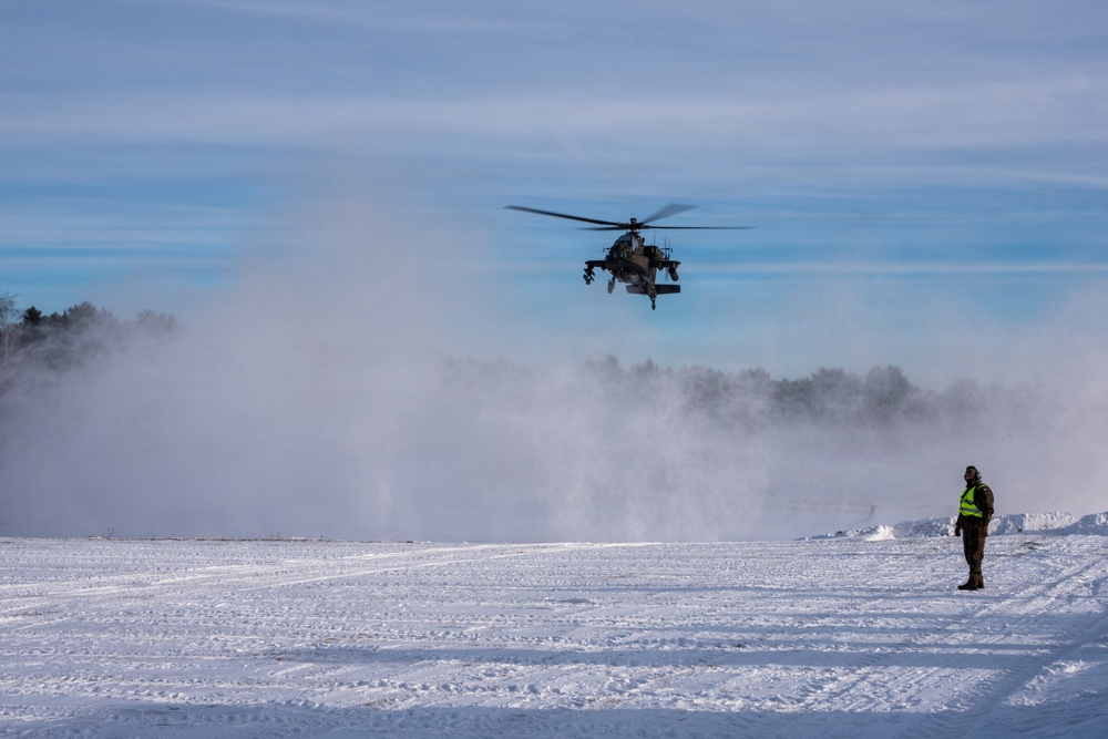 Polish AH-64 Apache land in a swirl of snow at Winter Falcon 26