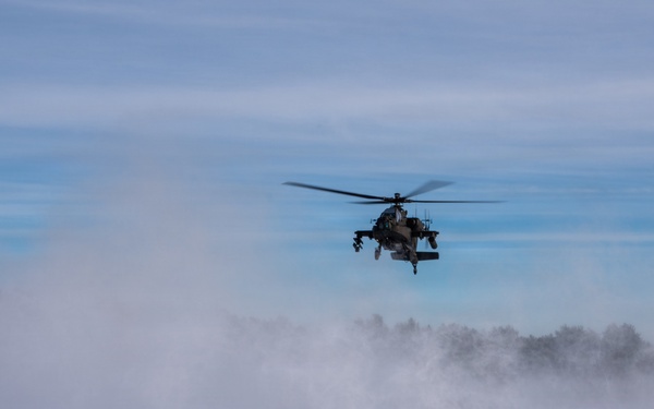 Polish AH-64 Apache land in a swirl of snow at Winter Falcon 26