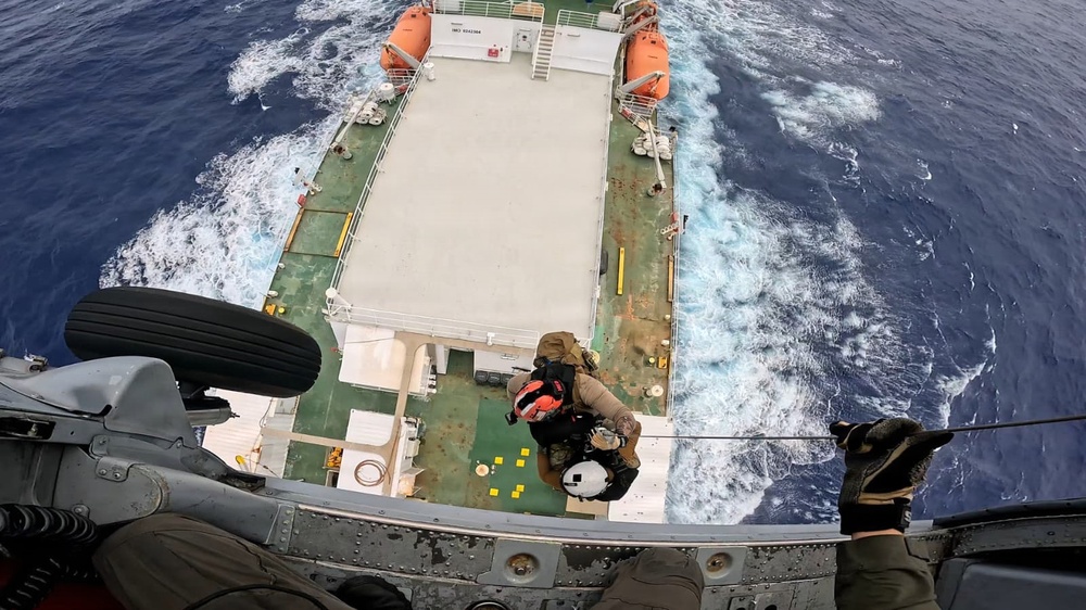U.S. Navy Helicopter Sea Combat Squadron 25 hoists ill mariner from vessel off Guam