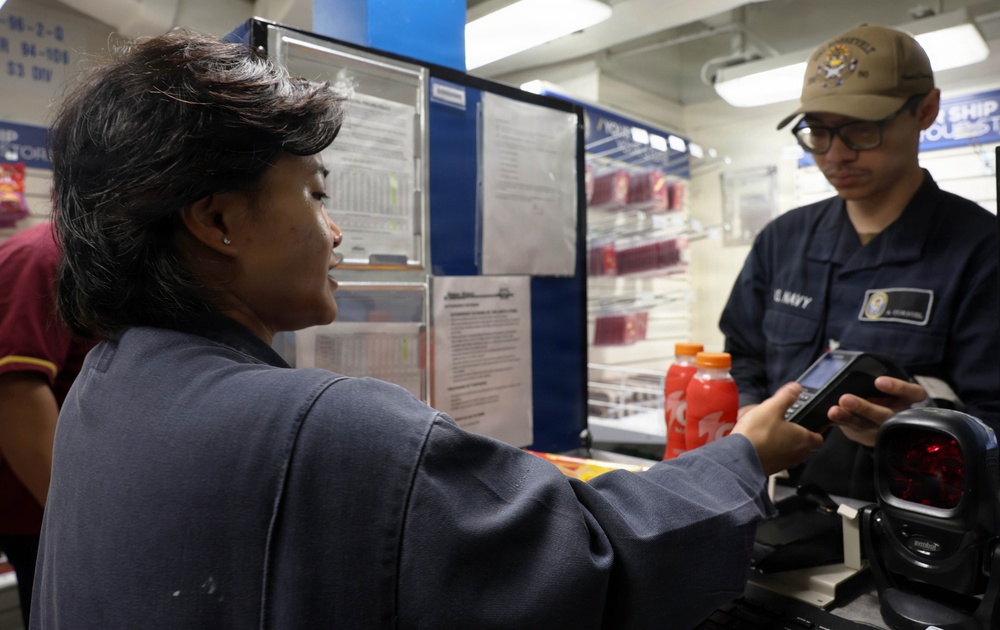 USS Roosevelt (DDG 80) Sailor Conducts Ship Store Transaction in the Red Sea