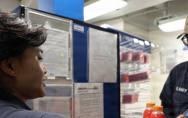 USS Roosevelt (DDG 80) Sailor Conducts Ship Store Transaction in the Red Sea