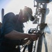 USS Mitscher (DDG 57) Sailor conducts deck preservation